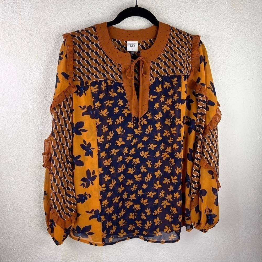 CAbi 100% Polyester Navy and Copper Top w/Tie neckline. Unique Ruffled Sleeves
